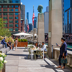 People sitting at tables outside.