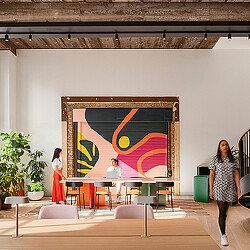 A group of people standing in front of a painting.