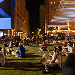 People gathered on AT&T Discovery District lawn